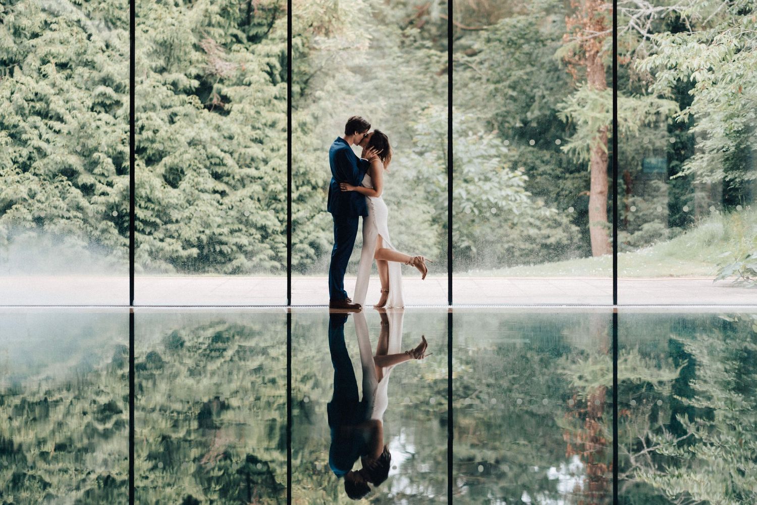 Cowley Manor Wedding Photographer Bride and Groom Kissing by the swimming pool