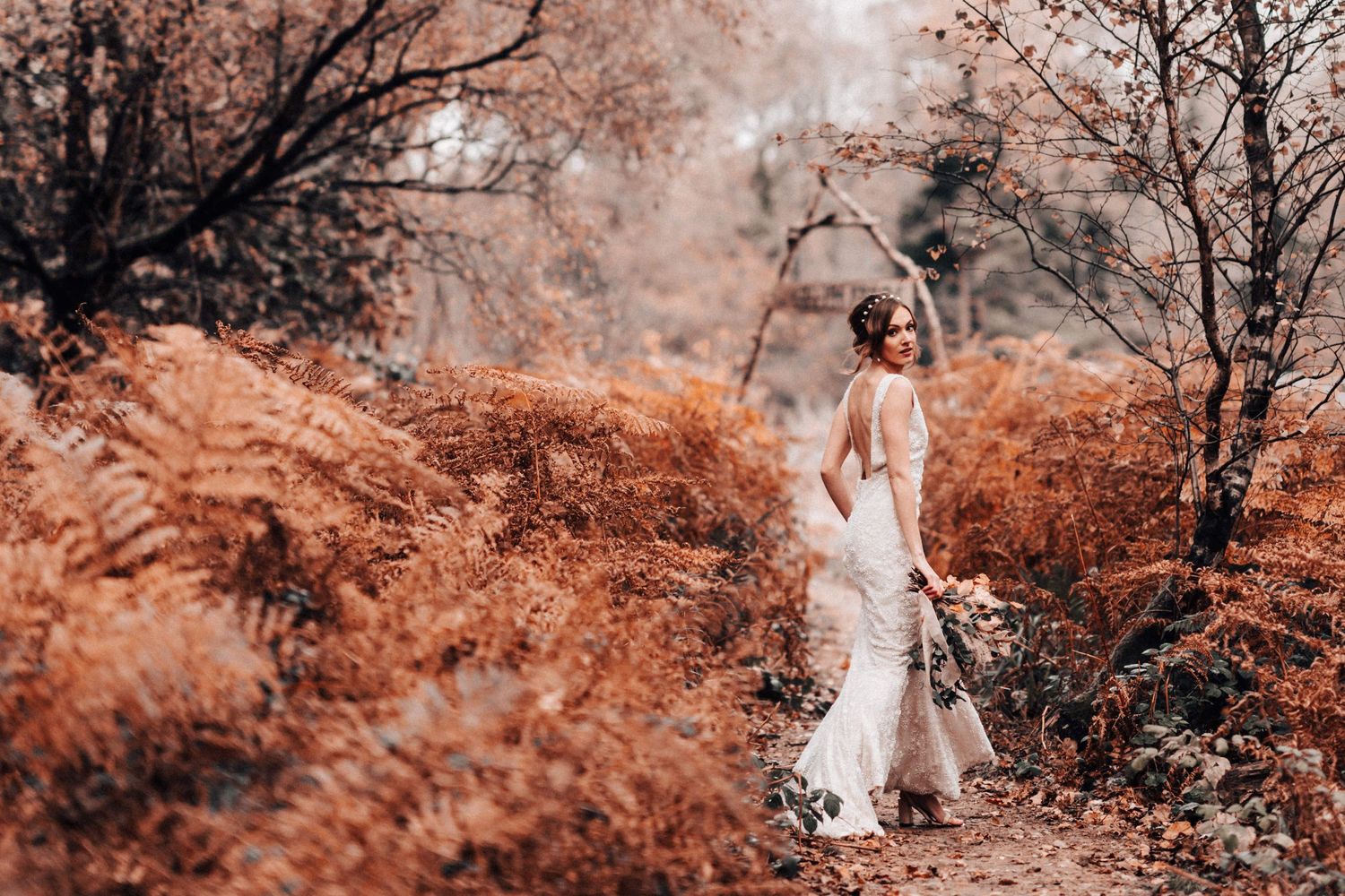 Savannah Miller Bridal Model in a forest wearing her dress